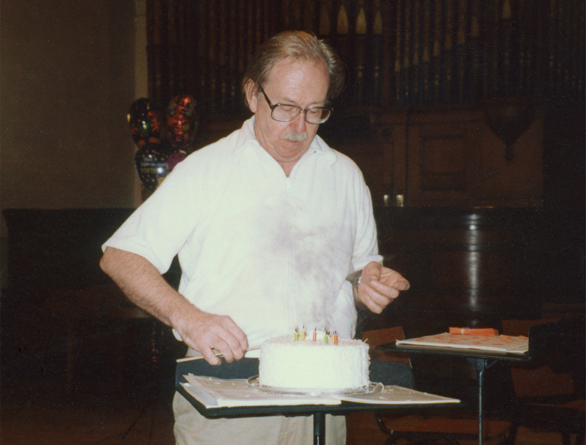 Jens Nygaard cutting a birthday cake with his chopstik-baton circa mid-1990s